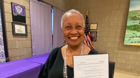 Springfield jazz singer Montenia Shider, holding a copy of the bill to make "Massachusetts" the state's official jazz song.