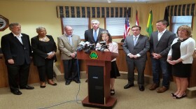 Hamilton County Commission President Denise Driehaus, flanked by Cincinnati and township leaders, announces a deal on water rates.