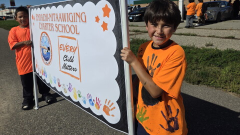 Endazhi Nitaawiging students Blaze and Damon hold a sign for the school's Orange Shirt Day walk on Sept. 30, 2026, in Red Lake.