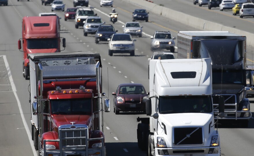 In this Aug. 24, 2016, file photo, truck and automobile traffic mix on Interstate 5, headed north through Fife, Wash., near the Port of Tacoma.