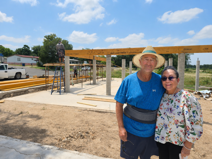 Scott and Juliet Welden in front of the construction of their new home in Kerrville