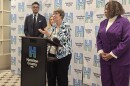 Working in Neighborhoods Executive Director Sister Barbara Busch speaks about a program designed to help some homeowners with back property taxes. Cincinnati Mayor Aftab Pureval, Hamilton County Treasurer Jill Schiller and Hamilton County Commissioner Stephanie Summerow Dumas are also pictured.