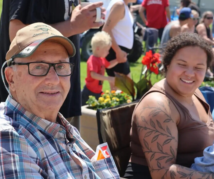 Tony Lazaruk sits on main street in Emerson, Manitoba | MPR News
