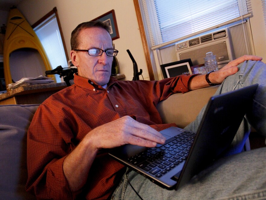 Kevin Evans relaxes in his small apartment after arriving home from work. Evans, who lost income and his home in the recession, is now having his wages garnished after falling behind on his credit card payments.