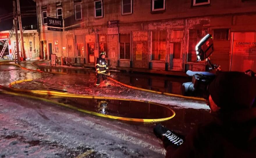 Firefighters battle a three-alarm fire on Custom House Wharf in Portland on Friday, Dec. 26, 2025.