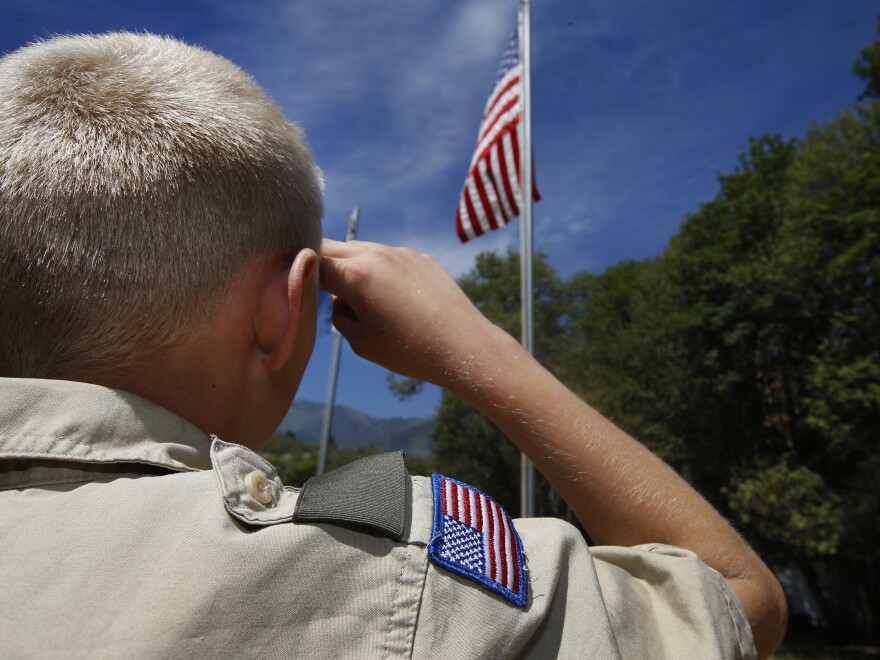 PAYSON, UT - JULY 31: A Boy Scout salutes the American flag at camp Maple Dell on July 31, 2015 outside Payson, Utah. The Mormon Church is considering pulling out of its 102 year old relationship with the Boy Scouts after the Boy Scouts changed it's policy on allowing gay leaders in the organization. Over 99% of the Boy Scout troops in Utah are sponsored by the Mormon Church. (Photo by George Frey/Getty Images)