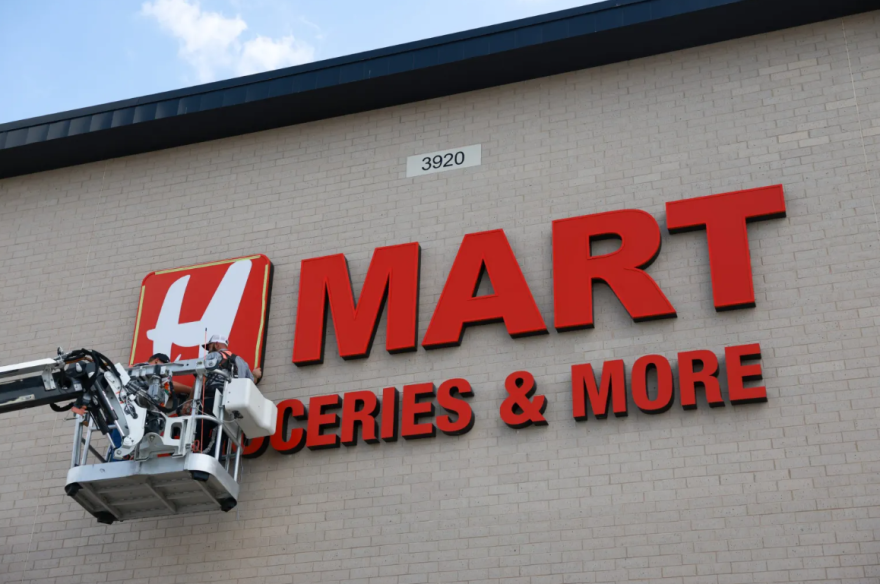 Workers put up the H Mart letters Sept. 18 in Haltom City.