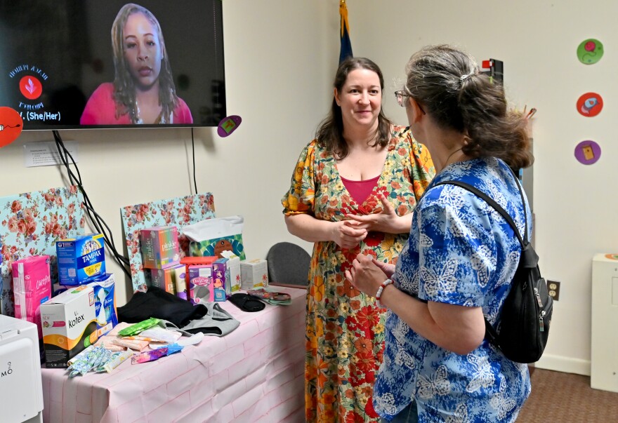 Nicole Guzenski, director of programs at the Catherine McAuley Center, talks to guests about period products.