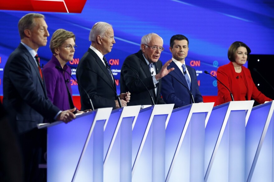 Sen. Bernie Sanders speaks as fellow candidates (from left) Tom Steyer, Sen. Elizabeth Warren, former Vice President Joe Biden, South Bend, Indiana Mayor Pete Buttigieg and Sen. Amy Klobuchar listen at Tuesday's primary debate.