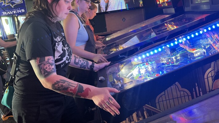 Members of Belles & Chimes Eugene playing pinball at The Flying Squirrel.