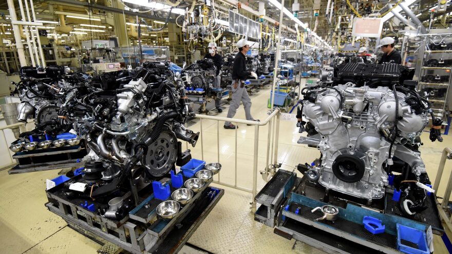 Employees work at the main assembly line of V-6 engines at a Nissan Motor plant in Iwaki, Japan, in 2016.