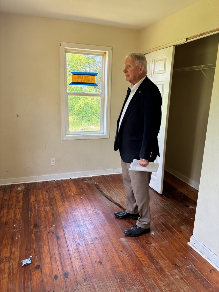 Commissioner Rob Zapple appraises the condition of a house that hasn't undergone any renovation yet.