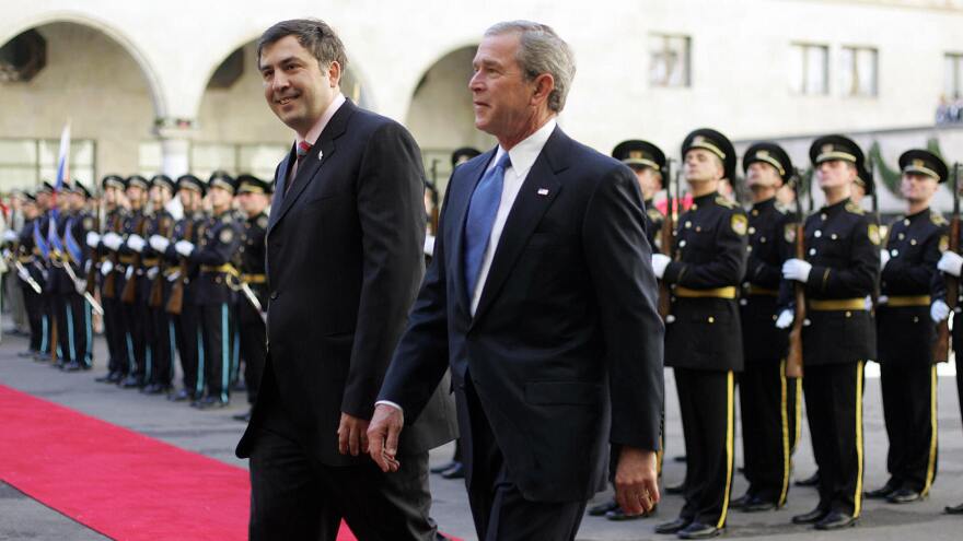 Mikhail Saakashvili, then Georgia's president, walks with President W. Bush during the latter's visit to Tbilisi in 2005.