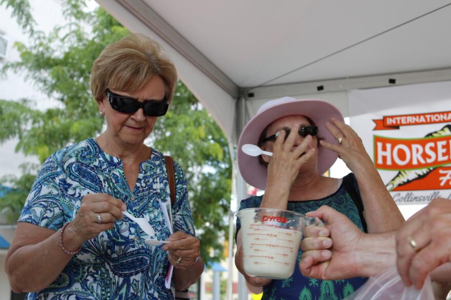Two taste-testers feel the burn after eating freshly blended horseradish at the festival in Collinsville, Illinois.