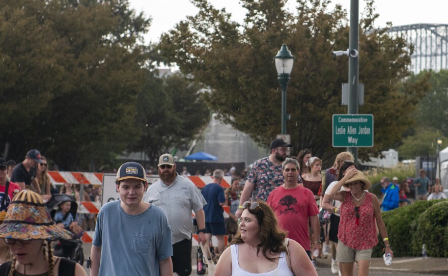 Festival goers evacuate Coolidge Park due to incoming storms on Saturday at Moon River 2023.