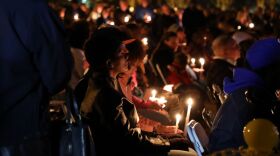 Mourners hold candles at a vigil for the victims of the shooting on Nov. 28, 2022. (Photo by Laura Philion)