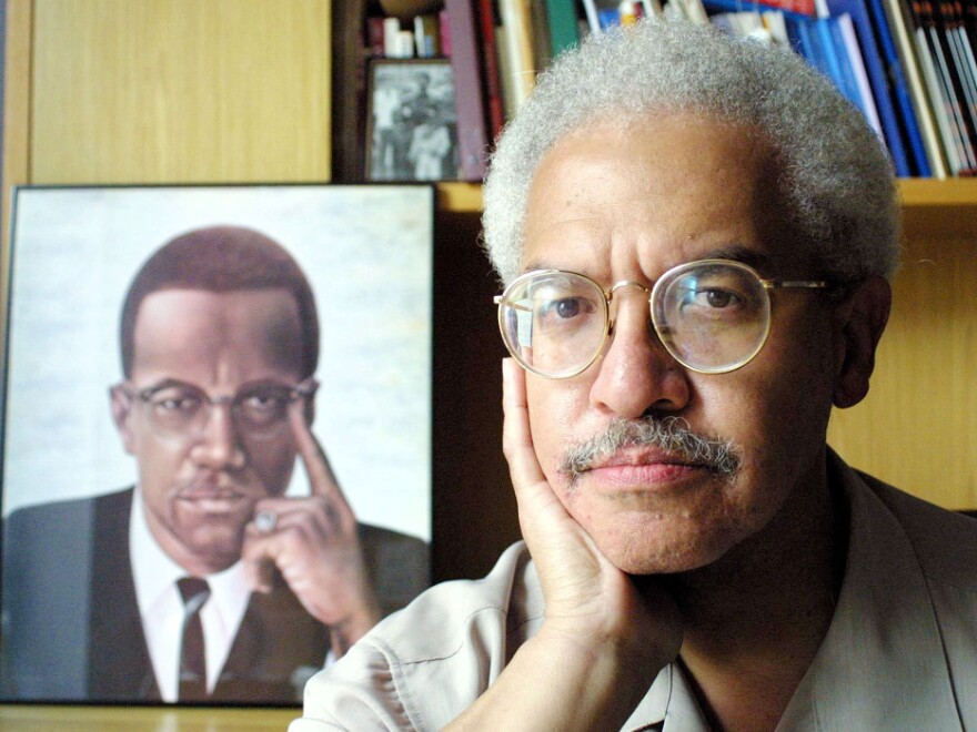 In his career, Manning Marable wrote about the struggle for equal rights — and especially the life of Malcolm X. In this file photo from 2001, he posed at his Columbia University office in New York.