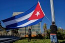 Workers fly the Cuban flag at half-mast at the Anti-Imperialist Tribune near the U.S. embassy in Havana, Cuba, Monday, Jan. 5, 2026, in memory of Cubans who died two days before in Caracas, Venezuela during the capture of Venezuelan President Nicolas Maduro by U.S. forces. (AP Photo/Ramon Espinosa)