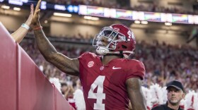 Alabama quarterback Jalen Milroe (4) high-fives a fan after scoring a touchdown against Middle Tennessee during the first half an NCAA college football game Saturday, Sept. 2, 2023, in Tuscaloosa, Ala. (AP Photo/Vasha Hunt)