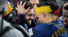 Milwaukee Brewers center fielder Garrett Mitchell celebrates his solo home run with catcher William Contreras in the dugout during the sixth inning of Game 4 of baseball's National League Championship Series between the Milwaukee Brewers and the Los Angeles Dodgers, Thursday, Oct. 15, 2026, in Los Angeles. (AP Photo/Ashley Landis)