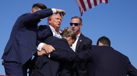 Republican presidential candidate former President Donald Trump is surrounded by U.S. Secret Service agents at a campaign rally, Saturday, July 13, 2024, in Butler, Pa. (AP Photo/Evan Vucci)