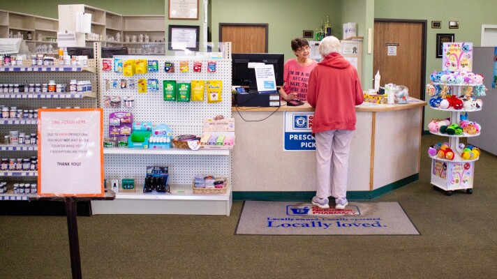 An associate serves a customer at the counter of independently owned Gateway Pharmacy, located in Clare, Michigan, on Monday, May 4, 2026.
