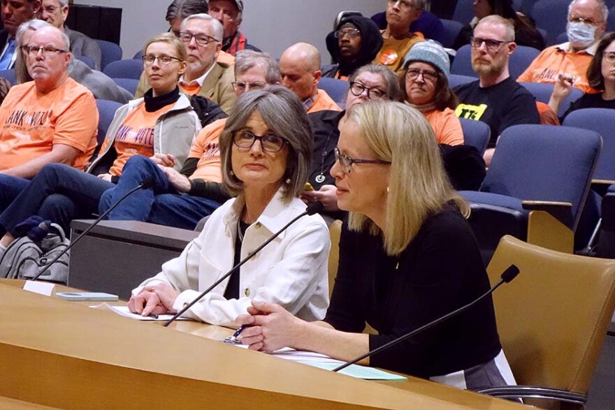 Advocates for ranked choice voting speak into a microphone on the state Senate floor