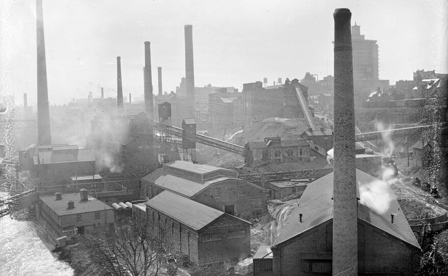 Incinerator and coal gasification construction, looking southeast from the Smith Street or Bausch Memorial Bridge, circa 1920. Kodak Tower is shown in the distance.