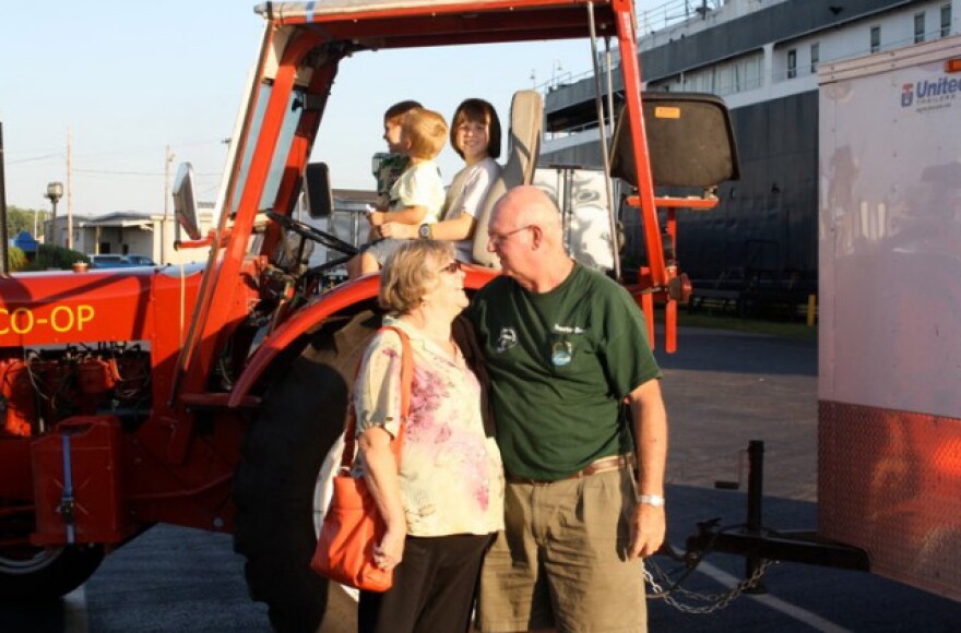 "Tractor Dave" returns home in Ludington, MI after a 4,100 mile tractor ride through the Midwest. His grandchildren sit on the tractor and his wife "Mrs. Tractor Deb" welcomes him home.