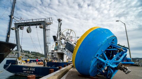 Massive buoys are loaded onto a National Science Foundation ship in Newport last year before being returned to the ocean after being refurbished. Now this month the foundation is ordering that they be removed from the water and stored somewhere.