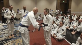 Michelle Cassady receiving her Royce Gracie black belt from Royce Gracie.