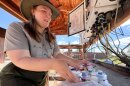 Bryce Canyon National Park scientist Rhiannon Garrard swaps out air filters as part of the park’s weekly air monitoring check-in, Aug. 19, 2025.