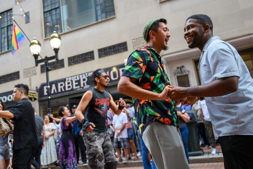 “Coming out into the streets like this, where it's like, open for everybody to just, like, join in dance and be with each other. I think that helps to, like, diffuse kind of, like, that tension and fear that we have at this time,” said Kevin Bun (left) while dancing with partner Ricky Belizaire who added “It’s connection, it’s community. We need more of that.”
