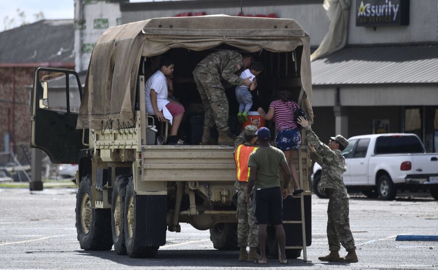 Members of the Louisiana National Guard help people in Laplace after Ida hit the region over the weekend.
