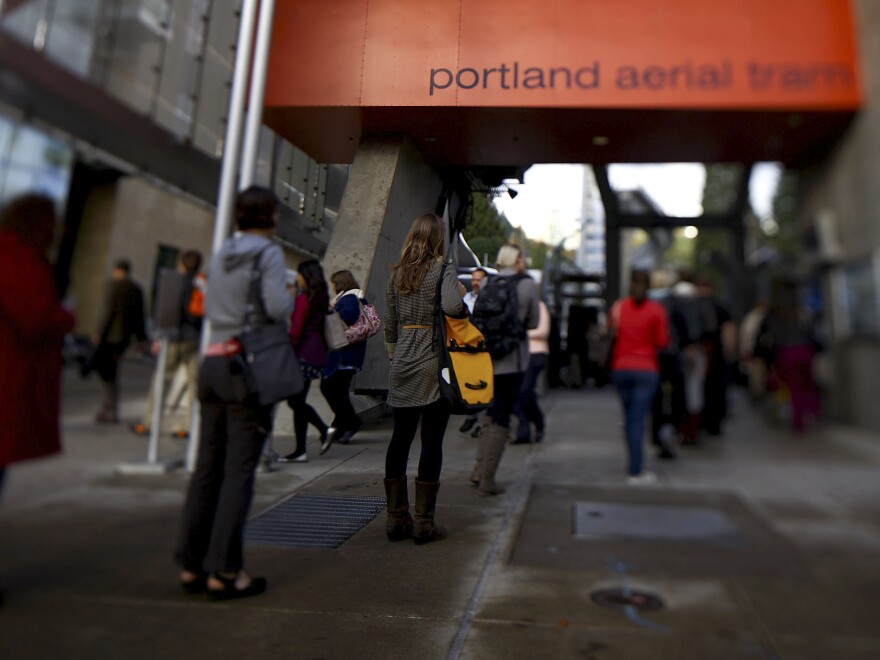 Passengers wait to board the aerial tram, which whisks them up and over Interstate 5 and surrounding neighborhoods.