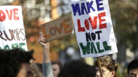 Students hold up signs during a walkout to protest the election of Donald Trump as president, Monday, Nov. 14, 2016, in Seattle. A spokesman with Seattle Public Schools estimates that about 2,300 students from 14 middle and high schools participated.