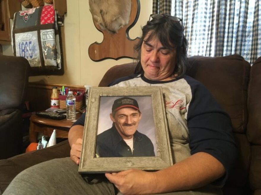 Vickie Salyers holds a photo of her husband Lowell “Gene” Salyers, who died from black lung in 2013.