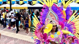 Junkanoo preformer dances in front of the street parade