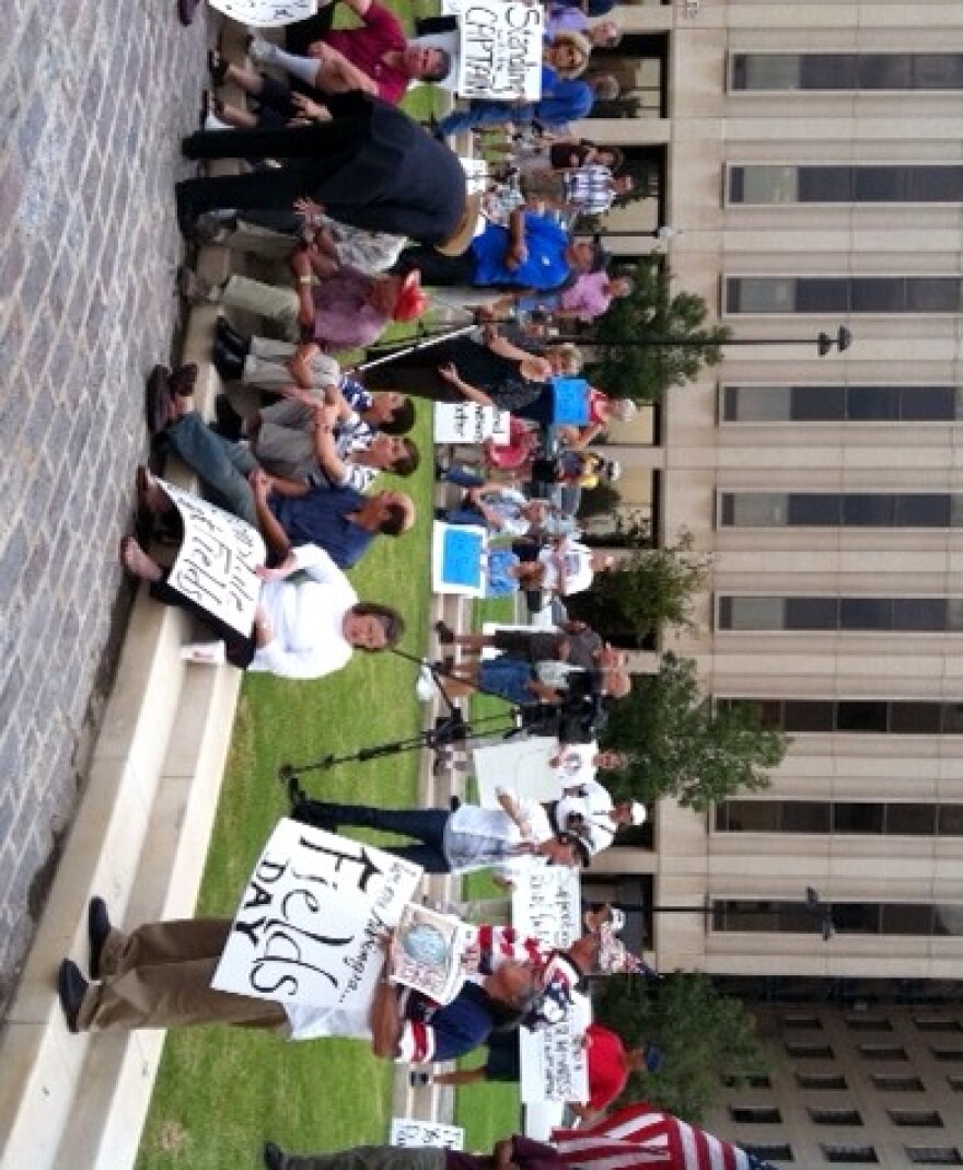 Protesters gather in a downtown park