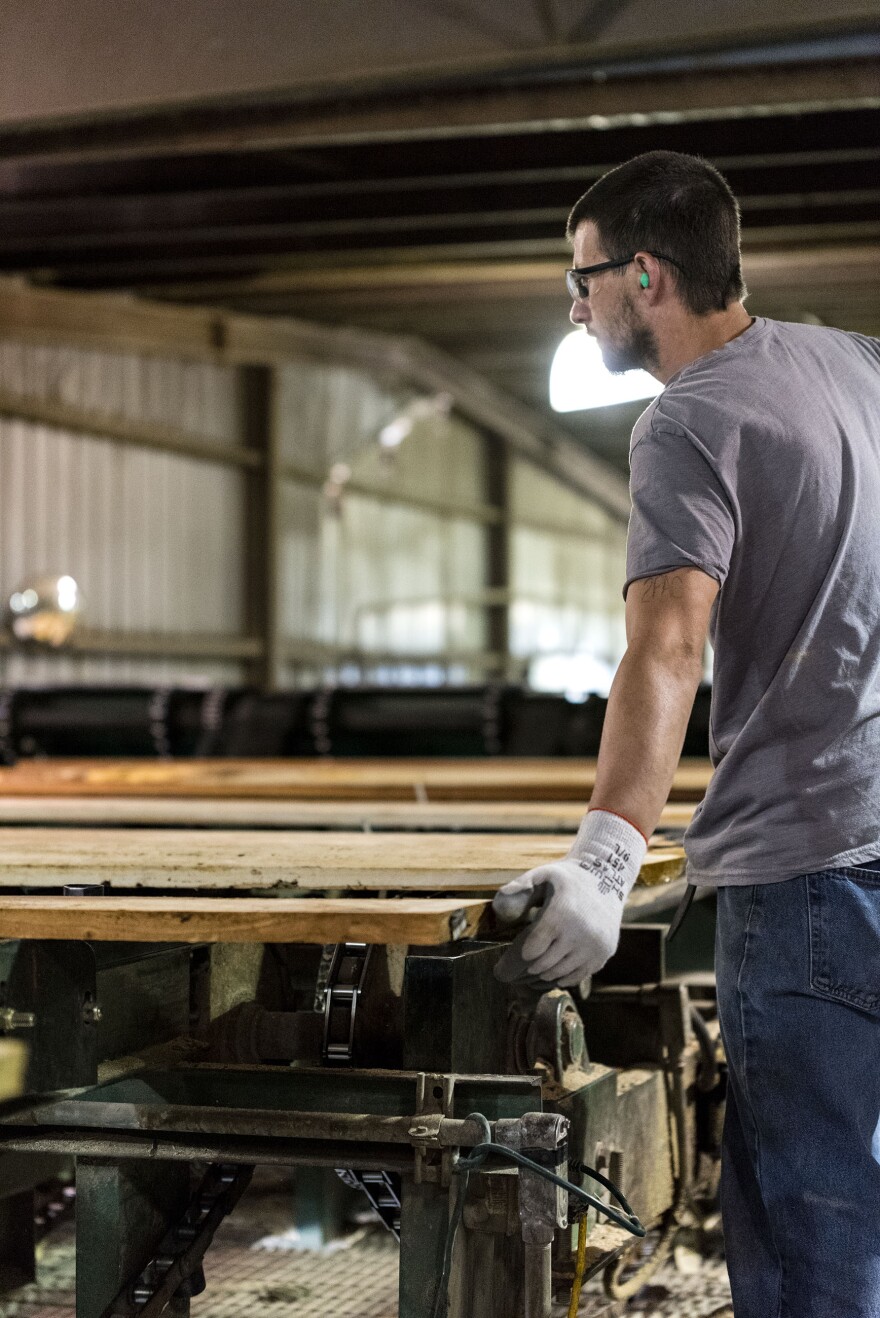 A grader marks boards near the end of the board-production process.