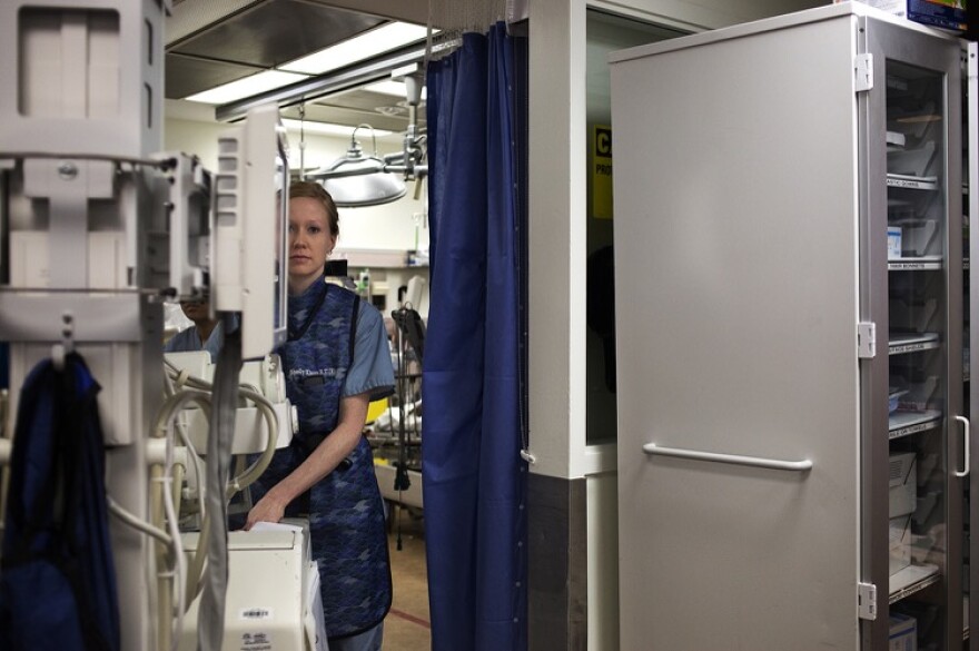 A radiologic technologist clears a trauma bay at St. Louis University Hospital's emergency room. A coalition of state medical groups have created new guidelines for prescribing opioids to patients in ERs and hospital settings. 