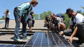 Former  US Rep. Gwen Graham launched her campaign for Governor this week. On Wednesday she helped attach solar panels to the roof of a house near Orlando, carrying on a  workdays campaign tradition started by her father, former Governor Bob Graham in the 1970s. Photo: Matthew Peddie, WMFE