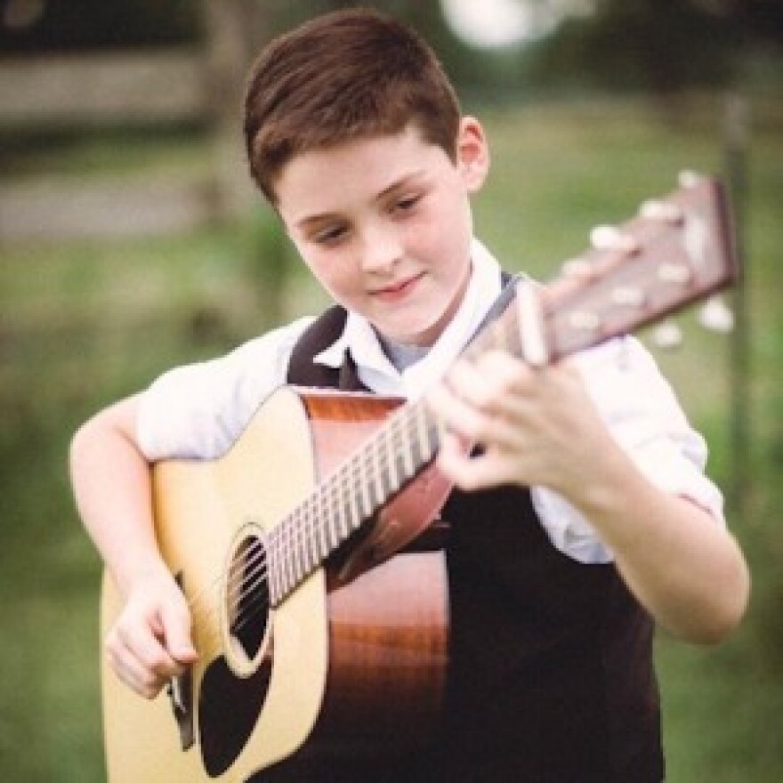 Young boy playing guitar