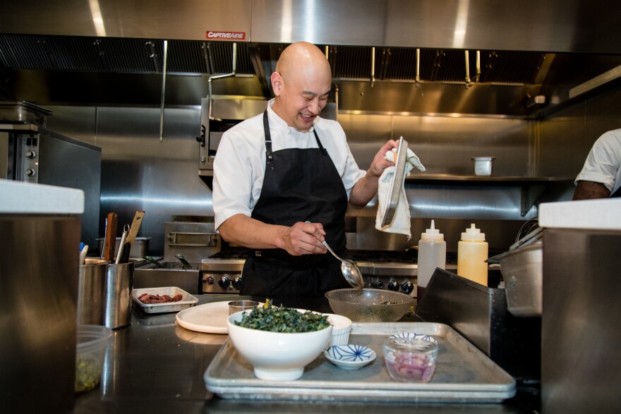 Tim Ma prepares a duck confit salad at his restaurant, Kyirisan, in Washington, D.C. Ma says being mindful about reducing food waste is an integral part of his philosophy in the kitchen — not just for environmental reasons but also for profitability.
