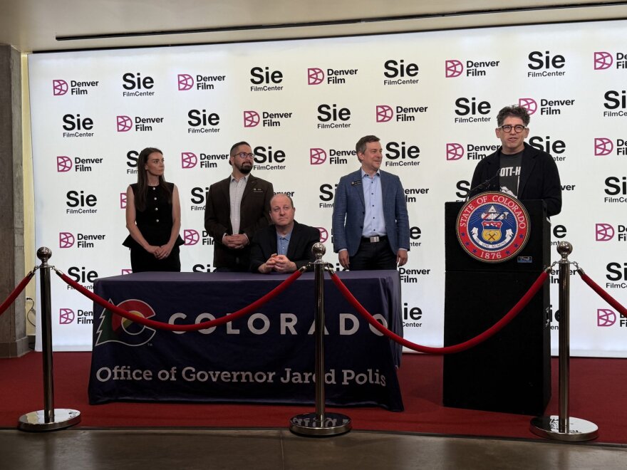 Yancey Strickler, co-founder of the crowdfunding platform Kickstarter, speaks at a bill signing for Senate Bill 133, which creates a new business structure in Colorado tailored to artists. Strickler came up with the idea and gave a TED talk on the concept in 2025. Colorado is the first state to enact the new structure, a subset of a limited liability corporation.