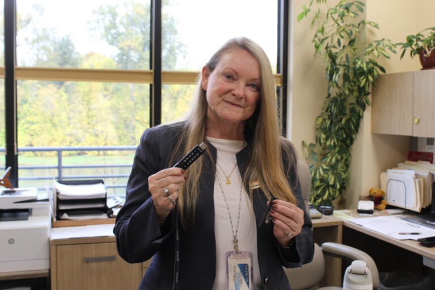Linn County Clerk Marcie Richey holds a flash drive that requires she input a code before she can record the results of the election and send to the Oregon Secretary of State on Nov. 3.