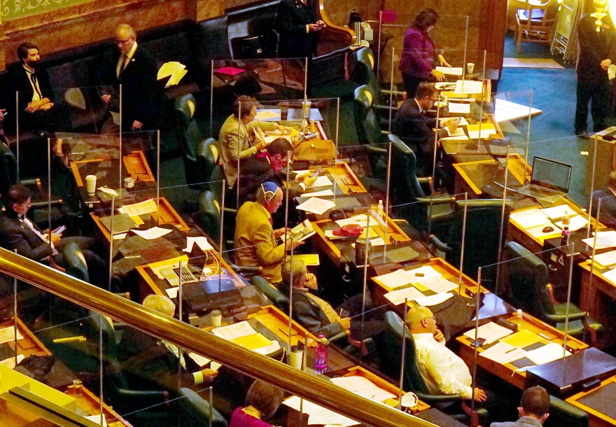 State Rep. Larry Liston, R-Colorado Springs, wears a blue mask over his head during the start of the special legislative session. Liston was one of several Republican lawmakers to go maskless during the proceedings at the Capitol, which are occuring during a surge of coronavirus cases nationwide.