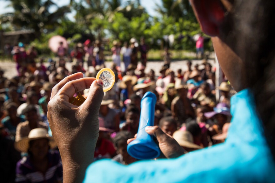 Nurse Olivia Haingoniaina demonstrates how to use a condom as part of a one-day clinic in the village of Ambohitsara.