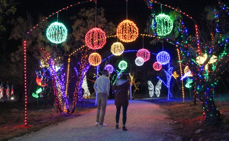Visitors walk under the arches at the United Way's 2021 Winter Light Fest.