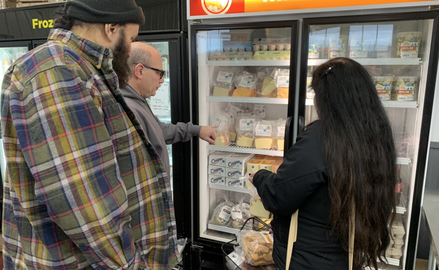 From left to right: Bill McDermott, Tommy DiDonato, and Julie McDermott shop for MudPond cheeses.